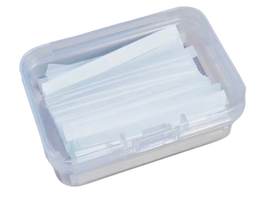 Clear plastic container with white paper strips on a white background