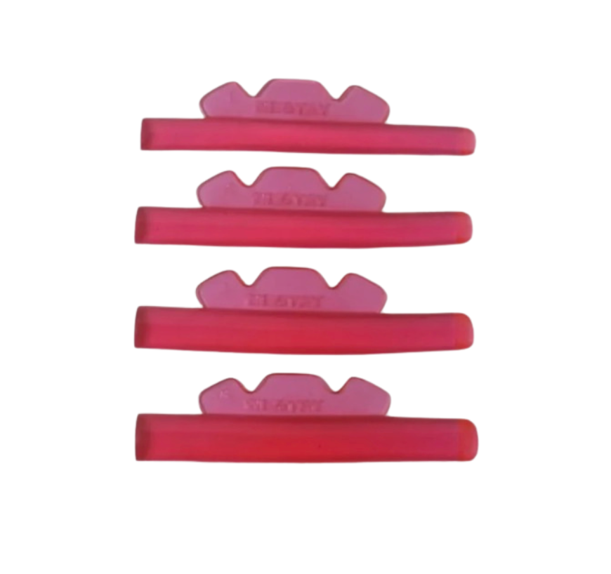 Set of red and pink silicone mold tools on a white background